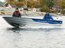 Two people in a moving fishing boat 